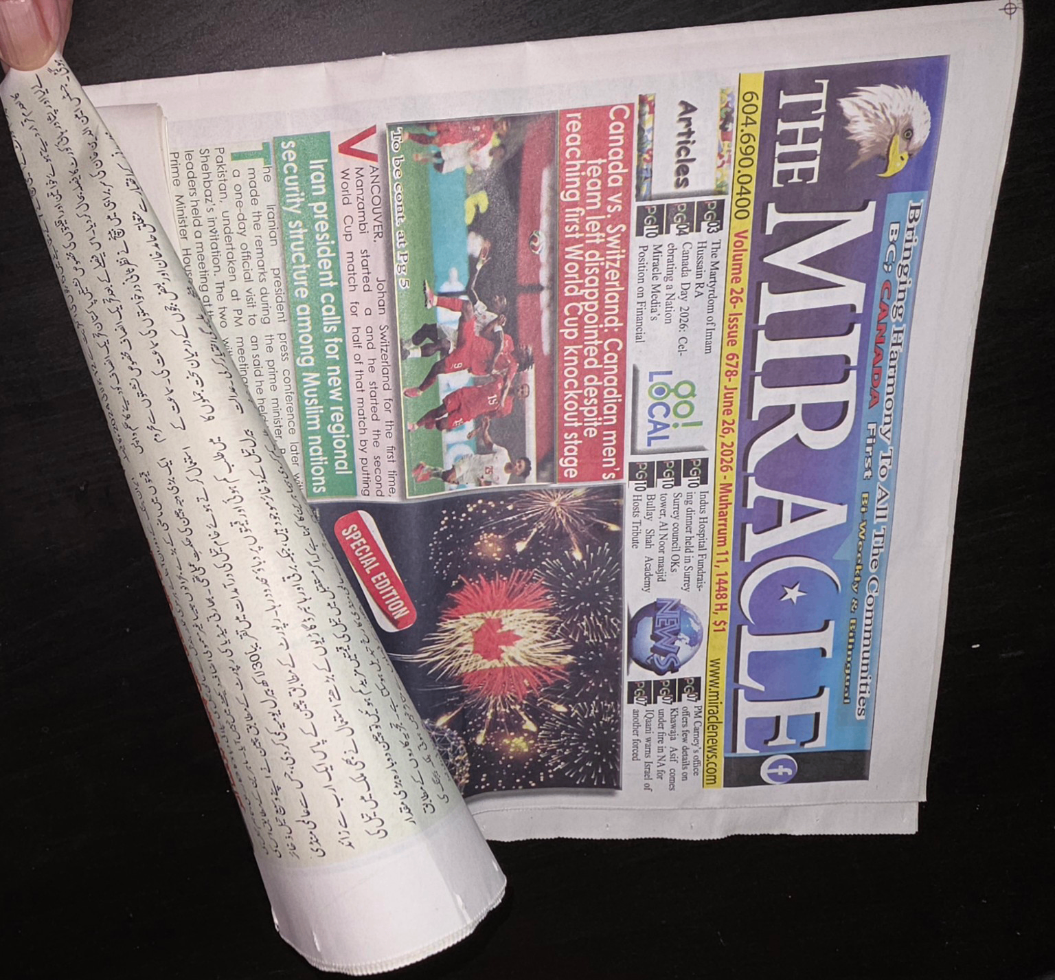 A folded issue of The Miracle newspaper, showing the gold masthead and front-page stories.